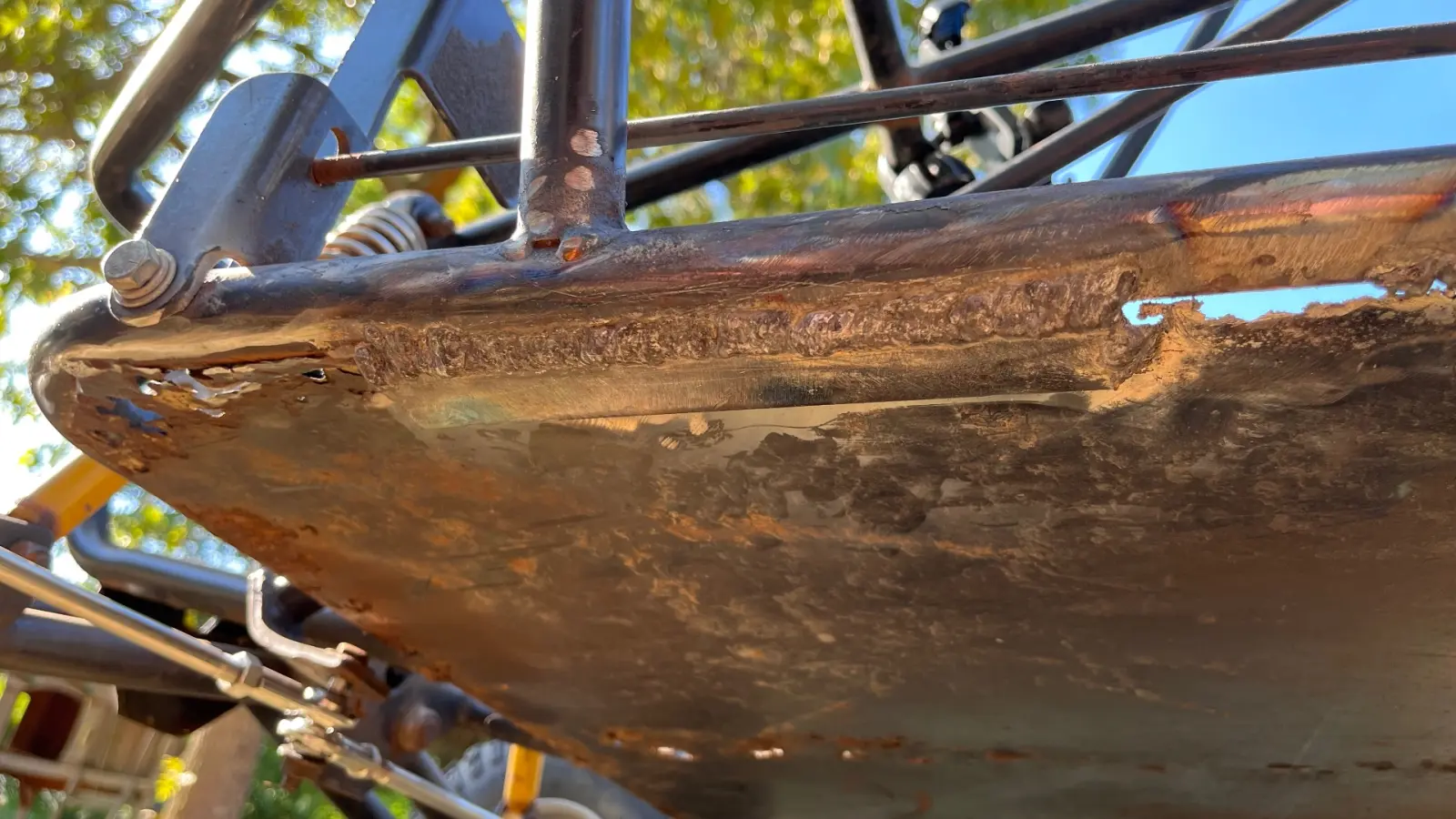 Welded skid plate and frame reinforcement on the underside of an off-road buggy