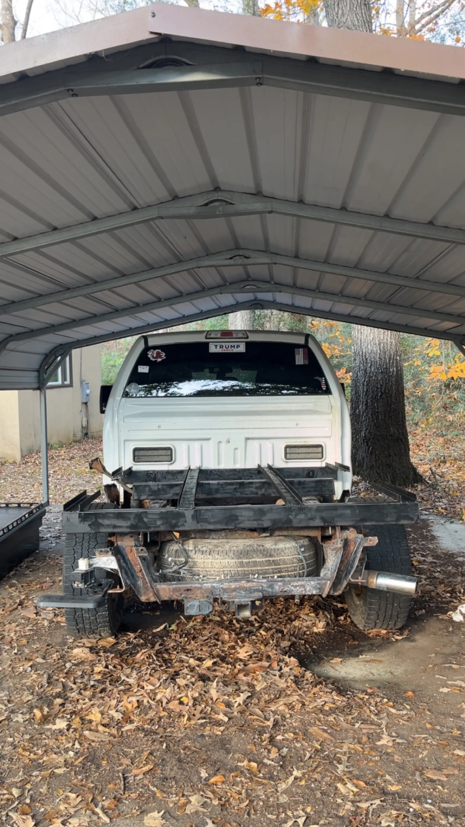 Rear view of custom flatbed frame fabrication on a pickup truck