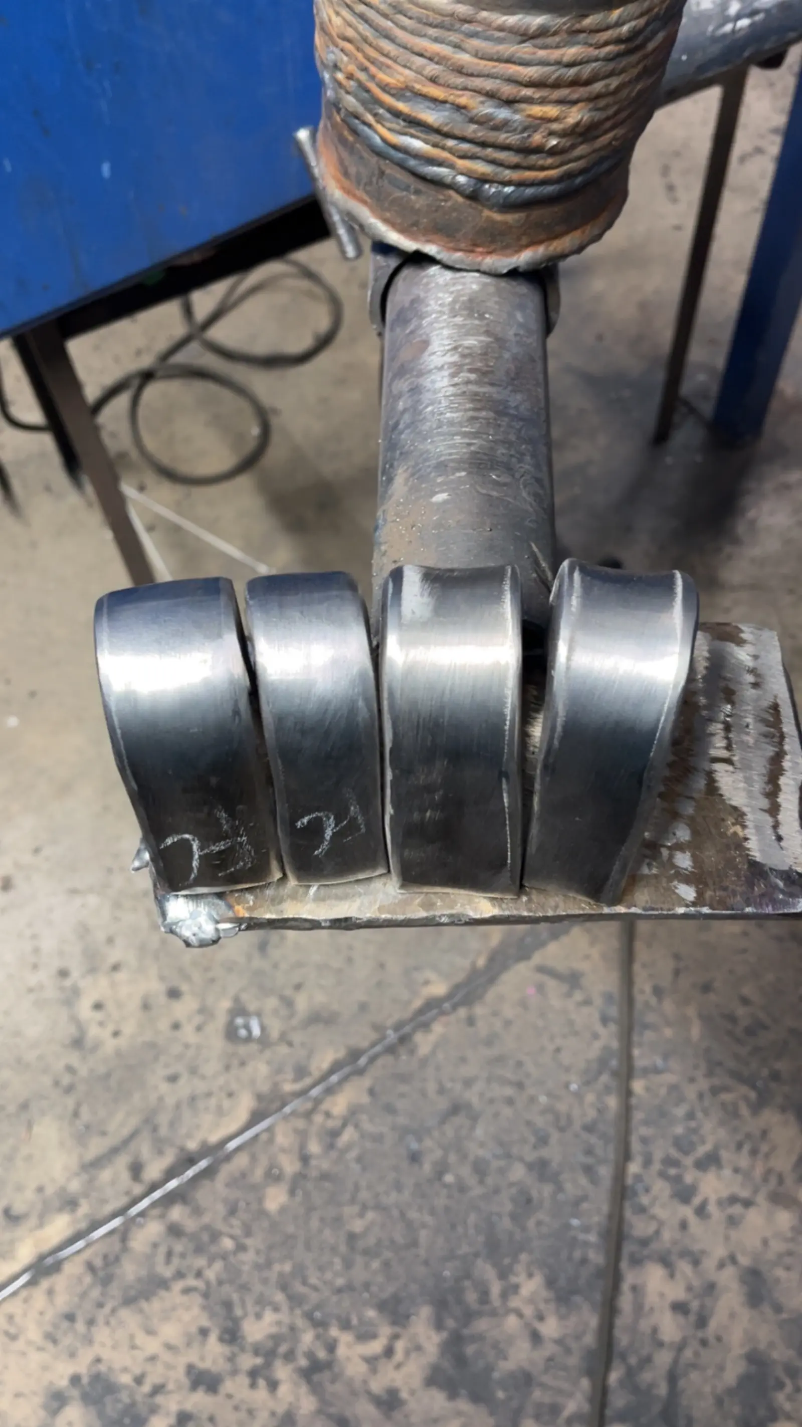 Stacked weld bead practice coupons showing tight uniform passes